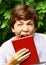 Yawning teen boy with book