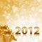 Year 2012 gold sparkling background and gold gift