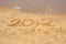 Year 2012 written in sand