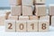 Year 2018 review or outlook and summary concept, cube wooden block with alphabet building the numbers 2018 on grid line notebooks