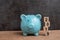 Year 2019 happy saving target, budget, investment or finance goals concept, blue piggy bank and stack of cube wooden block