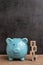 Year 2019 happy saving target, budget, investment or finance goals concept, blue piggy bank and stack of cube wooden block