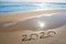 year 2020 numbers spell written on beach