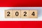 year 2024, Black inscription on a white red background, New Year, forecasts, calendar