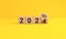 The year 2024 target dart on yellow background. 2024 business planning and strategy concept. investment trends next new year