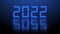Year change 2022 - blurred blue year digits with reflection effects on structured surface over illuminated background