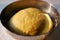 Yeast dough proofing in metal bowl with sunset sunlight