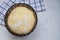 Yeast pastry dough in a brown glass bowl.