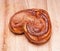 Yeast sweet buns in the shape of a heart on an wooden table. Country house style. Authentically