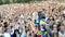 Yekaterinburg, Russia-August, 2019: Singing artist on background of fans. Action. Rear view of singer with singing crowd