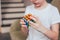 Yekaterinburg, Russia - March, 01, 2019. Crop portrait of boy with a Rubik`s cube at home close up