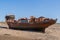 YELLAND, NORTH DEVON, UK - MAY 28 2020: Abandoned broken ship wreck, on sandy shore. Rusting hull on beach.