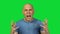 Yelling bald man on green background