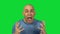 Yelling young bald man on green background
