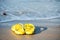 Yelllow flip flops or sandals on beach. Holiday