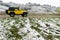 Yellow 4x4 jeep on snow covered mountain road