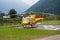 The yellow alpine rescue helicopter stationary on the ground
