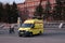 Yellow ambulance near the Lenin monument on Lenin square