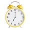Yellow analog alarm clock showing seven o`clock isolated on white background