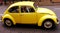 Yellow antique car: volkswagen beetle.