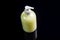 Yellow antiseptic liquid soap in a bottle with a dispenser on a black background. Top view, close-up. Horizontal orientation