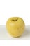 Yellow Apple Closeup on White Plate