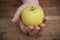 Yellow apple temptation concept on wooden table