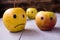 Yellow apples with drawn emotions