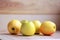 Yellow apples scattered on the wooden floor