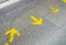 Yellow arrow sign indicate on marble floor