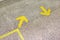 Yellow arrow sign indicate on marble floor, On the subway