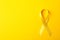 Yellow awareness ribbon on color background
