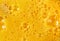 Yellow background of beaten chicken eggs with bubbles texture