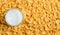 Yellow background of corn flakes. Milk in a glass. Healthy and nutritious Breakfast. Copy space