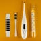 On a yellow background, there are four types of thermometers - liquid crystal, clinical, electric and mercury. Concept of health