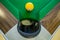 Yellow ball near the pocket of billiard table