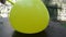 Yellow balloon cutting with a sharp knife slow motion