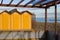 Yellow beach cabins of a bathhouse on the sand in the Mediterranean coast Italy, Europe