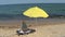 Yellow beach umbrella and bed
