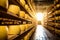 Yellow and beautiful cheese heads are stored on wooden shelves, in warehouse of factory where it is produced
