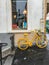 Yellow bicycle leans against outside of Art and Design shop, Paris, France