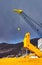 Yellow big roro vessel in a shipyard with a crane against grey sky