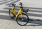 Yellow bike with parking at the bike rack on stone street