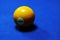 Yellow billiard ball number 1 on a blue billiard table.