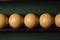 Yellow billiard balls and cue ball for billiards on the shelf,close up
