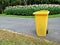 Yellow bins in public park beside the walk way.