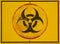 Yellow biohazard danger sign closeup with black border.