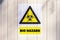 Yellow biological hazard warning sign on the wall