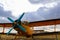 Yellow biplane from front standing on airports with cloud sky