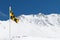 Yellow and black avalanche risk warning flag flying in the mount